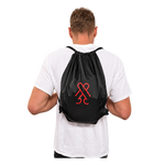 Model wearing the black CockBlock® Drawstring Bag on his back
