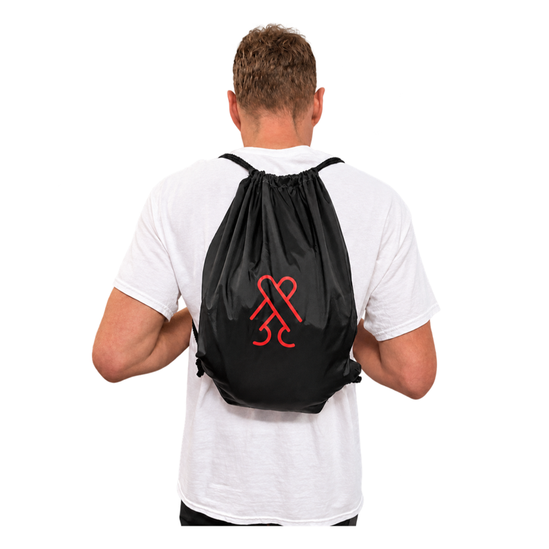 Model wearing the black CockBlock® Drawstring Bag on his back
